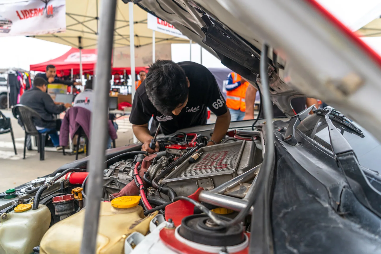 Mechanic inspecting a car engine before purchase